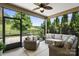 Relaxing screened patio with ceiling fan and comfortable seating overlooking the outdoor landscape at 4975 Looking Glass Trl, Denver, NC 28037