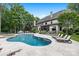 Beautiful backyard featuring a large pool, lounge chairs, and a well-maintained patio area for relaxation at 5523 Meadow Haven Ln, Charlotte, NC 28270