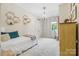 Whimsical bedroom with birch-themed wallpaper, decorative shelves, and unique lighting at 5523 Meadow Haven Ln, Charlotte, NC 28270