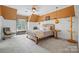 Inviting bedroom with unique lighting fixtures, large window, and cozy decor offering a relaxing and stylish atmosphere at 5523 Meadow Haven Ln, Charlotte, NC 28270