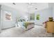 Serene bedroom with vaulted ceilings, soft blue walls, carpet flooring, and large windows providing ample natural light at 5523 Meadow Haven Ln, Charlotte, NC 28270
