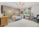 Serene bedroom featuring a decorative wall, soft lighting, and a large window offering a peaceful retreat at 5523 Meadow Haven Ln, Charlotte, NC 28270