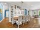 Formal dining room with stylish decor, built-in shelving, and a view at 5523 Meadow Haven Ln, Charlotte, NC 28270