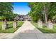 Stately home with a long driveway, lush landscaping, a stone exterior, and a three-car garage at 5523 Meadow Haven Ln, Charlotte, NC 28270