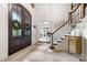 Grand foyer featuring soaring ceilings, a staircase, and abundant natural light at 5523 Meadow Haven Ln, Charlotte, NC 28270