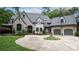 Charming stone home featuring a circular driveway and landscaped front yard with beautiful water fountain at 5523 Meadow Haven Ln, Charlotte, NC 28270