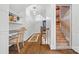 Upstairs hallway with hardwood floors, access to the unfinished attic, and stylish lighting at 5523 Meadow Haven Ln, Charlotte, NC 28270