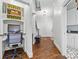 Inviting hallway with hardwood floors, built-in desk, and convenient access to various areas of the home at 5523 Meadow Haven Ln, Charlotte, NC 28270