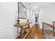 Bright hallway with wood floors, shiplap walls, and stylish decor creating an inviting and elegant transition space at 5523 Meadow Haven Ln, Charlotte, NC 28270