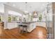 Modern kitchen with stainless steel appliances and a large center island at 5523 Meadow Haven Ln, Charlotte, NC 28270