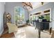 Elegant living room featuring large windows with great views, vaulted ceilings, and a grand piano at 5523 Meadow Haven Ln, Charlotte, NC 28270