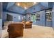 Spacious living room with custom built-ins, comfortable leather seating, and ample natural light, perfect for relaxation and entertainment at 5523 Meadow Haven Ln, Charlotte, NC 28270