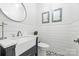 Chic powder room with a modern vanity, stylish fixtures, and elegant decor creating a sophisticated and functional space at 5523 Meadow Haven Ln, Charlotte, NC 28270