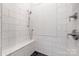 Modern shower featuring white subway tiles, a built-in seat, and sleek fixtures at 5523 Meadow Haven Ln, Charlotte, NC 28270