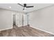This bedroom has wood-look floors, a ceiling fan, neutral paint and access to a bathroom at 626 W Bell St, Statesville, NC 28677