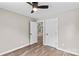 Bedroom with wood-look flooring, a ceiling fan and access to other rooms at 626 W Bell St, Statesville, NC 28677