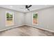 This bedroom has wood-look floors, neutral paint, and two large windows at 626 W Bell St, Statesville, NC 28677