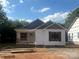 Charming single-story home with white siding, dark shutters, covered porch and architectural details at 626 W Bell St, Statesville, NC 28677