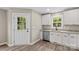 Bright kitchen features white cabinetry, granite countertops, stainless steel appliances, and an exterior door at 626 W Bell St, Statesville, NC 28677