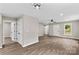 Open-concept living space boasting modern lighting, ceiling fan, and vinyl floors at 626 W Bell St, Statesville, NC 28677