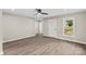 Bright living room featuring vinyl floors, a ceiling fan, and natural light streaming through the windows at 626 W Bell St, Statesville, NC 28677