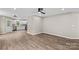 Open living space featuring vinyl floors that connect to the kitchen with white cabinets and stainless appliances at 626 W Bell St, Statesville, NC 28677