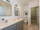 Bright bathroom with double sink vanity and walk-in closet offers ample storage at 6505 Central Pacific Ave, Charlotte, NC 28210