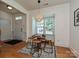Breakfast nook features hardwood floors, decorative pendant lighting, and natural light from a large front window at 6505 Central Pacific Ave, Charlotte, NC 28210