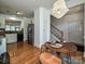 Cozy dining area with a round table, adjacent to a kitchen and stairway at 6505 Central Pacific Ave, Charlotte, NC 28210