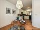 Bright dining area featuring a round wood table, statement light fixture, and modern art at 6505 Central Pacific Ave, Charlotte, NC 28210
