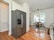 Stainless-steel refrigerator in a kitchen next to a dining area with natural light at 6505 Central Pacific Ave, Charlotte, NC 28210
