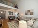 Inviting living room with hardwood floors, stylish furniture, and a view of the dining area from the mezzanine at 6505 Central Pacific Ave, Charlotte, NC 28210