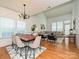 Open-concept living area with a combined dining and living space, featuring hardwood floors and abundant natural light at 6505 Central Pacific Ave, Charlotte, NC 28210