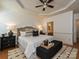 Spacious main bedroom featuring a ceiling fan, tray ceiling and ensuite bathroom entrance at 6505 Central Pacific Ave, Charlotte, NC 28210