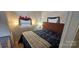 The bedroom is well-lit and has a comfortable-looking bed at 6641 Monford Dr # 54, Conover, NC 28613