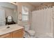 Bathroom with shower and tub and an oak vanity at 7007 Broad Leaf Ct, Indian Trail, NC 28079