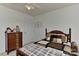A cozy bedroom featuring a decorative wood bed frame, ceiling fan and neutral decor at 7007 Broad Leaf Ct, Indian Trail, NC 28079