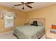 Sunlit bedroom featuring a ceiling fan, neutral decor and a large window at 7007 Broad Leaf Ct, Indian Trail, NC 28079