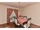 Cozy dining room with hardwood floors, chandelier, and patterned red table cloth at 7007 Broad Leaf Ct, Indian Trail, NC 28079