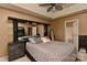 Spacious main bedroom with tray ceiling, fan, and dressing mirror at 7007 Broad Leaf Ct, Indian Trail, NC 28079