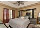 Spacious main bedroom with tray ceiling, fan, and unique headboard with lighting at 7007 Broad Leaf Ct, Indian Trail, NC 28079
