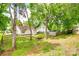 View of the backyard with mature trees, a firepit, storage shed, and wood fence at 7442 Crestside Ln, Charlotte, NC 28227