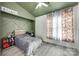 A secondary bedroom with a ceiling fan, decorated in a sports theme with soft lighting at 7442 Crestside Ln, Charlotte, NC 28227