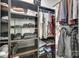 A spacious walk-in closet, fully stocked with shelving and clothes-hanging rods at 7442 Crestside Ln, Charlotte, NC 28227