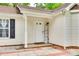 Close-up of home's front entrance with sidelight, covered porch and 'Home' welcome decor at 7442 Crestside Ln, Charlotte, NC 28227