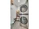 Modern laundry room features a stacked washer and dryer and shelving for storage at 7442 Crestside Ln, Charlotte, NC 28227