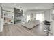 Open-concept living room featuring wood floors, fireplace, built-in shelving, and abundant natural light at 7442 Crestside Ln, Charlotte, NC 28227