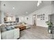 Bright living room showcasing hardwood floors, an open layout to the kitchen, and a comfortable sectional sofa at 7442 Crestside Ln, Charlotte, NC 28227