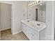 Bright bathroom with double vanity, white cabinets, and a large mirror with stylish lighting fixtures at 752 Raindrops Rd, Gastonia, NC 28054