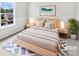 Staged bedroom featuring a serene aesthetic, soft lighting, and a comfortable king-sized bed at 752 Raindrops Rd, Gastonia, NC 28054